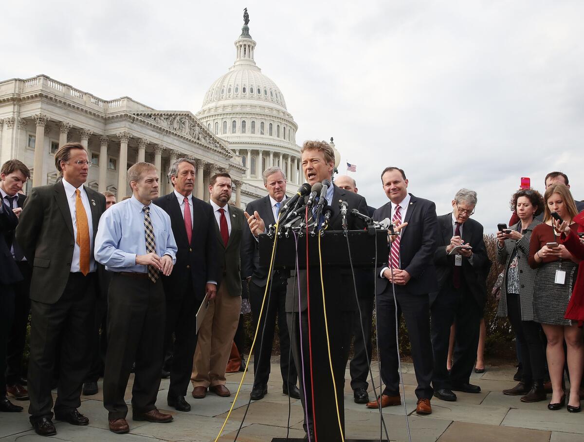 Sen. Rand Paul (R-Ky.) and members of the House Freedom Caucus are shown at a press conference.