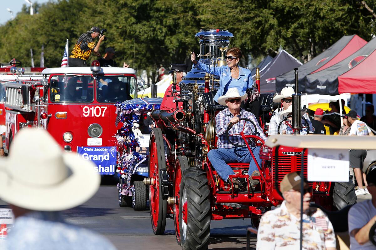 Cruisin' for a Cure car show organizer Debbie Baker leads a procession of cars at the Orange County Fairgrounds on Saturday.