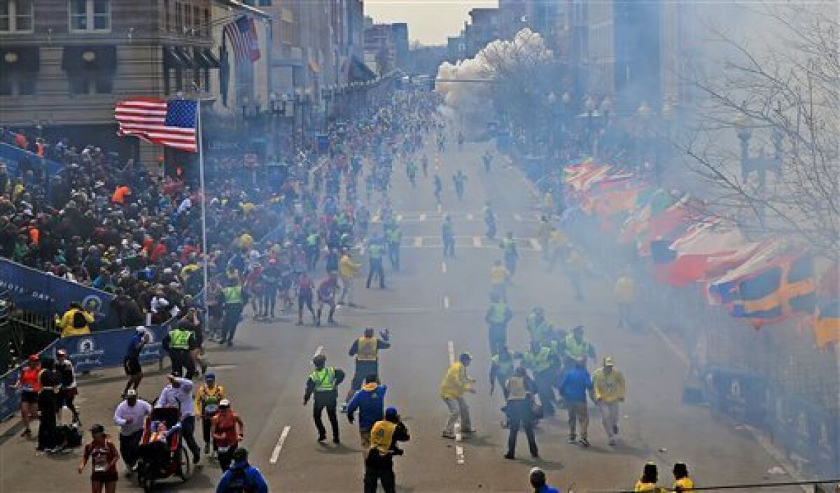 People react to explosions near the finish line of the 2013 Boston Marathon. 