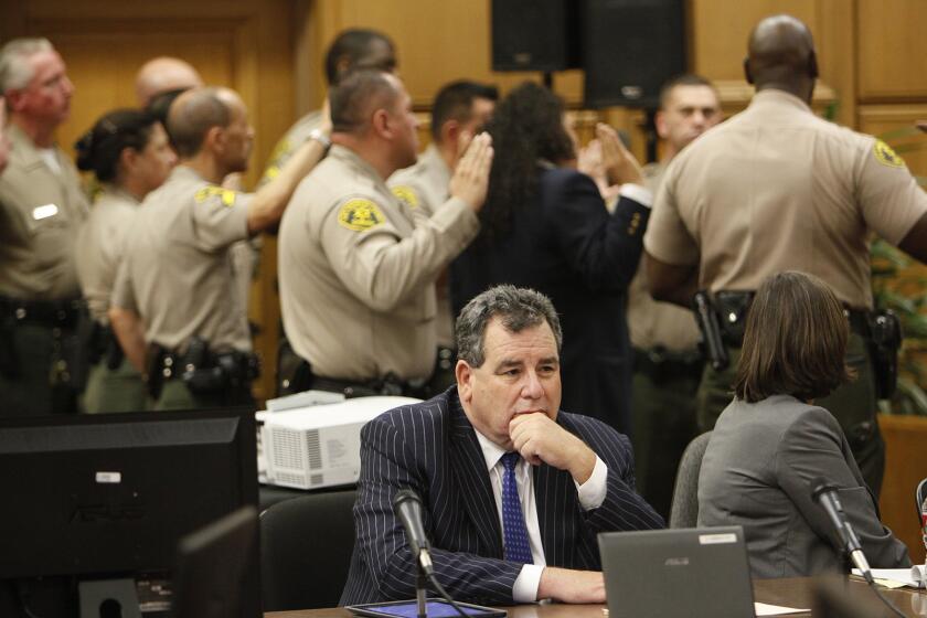 Michael Jackson family attorney Brian Panish sits in a downtown Los Angeles courthouse as bailiffs are sworn in to protect jury.