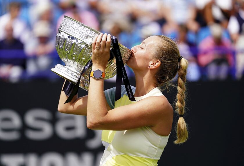 Czech Republic's Petra Kvitova celebrates with the trophy after winning the women's singles final match against Latvia's Jelena Ostapenko on day eight of the Rothesay International Eastbourne at Devonshire Park, Eastbourne, Britain, Saturday June 25, 2022. (Adam Davy/PA via AP)