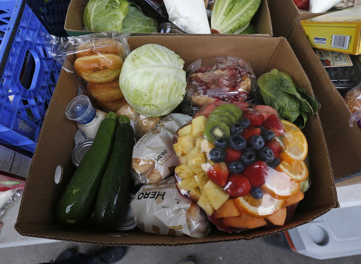 A fresh box of produce goes out to a family in need at the Laguna Food Pantry on Wednesday.