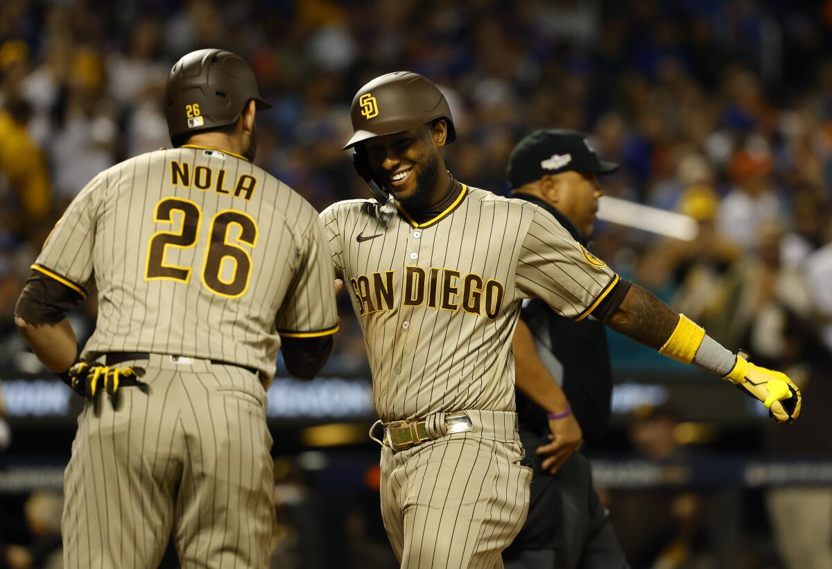The Padres' Jurickson Profar celebrates a three-run home run with Austin Nola 