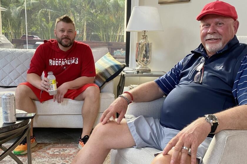Buccaneers coach Bruce Arians sits in his Tampa home with son Jake the morning after winning Super Bowl LV.