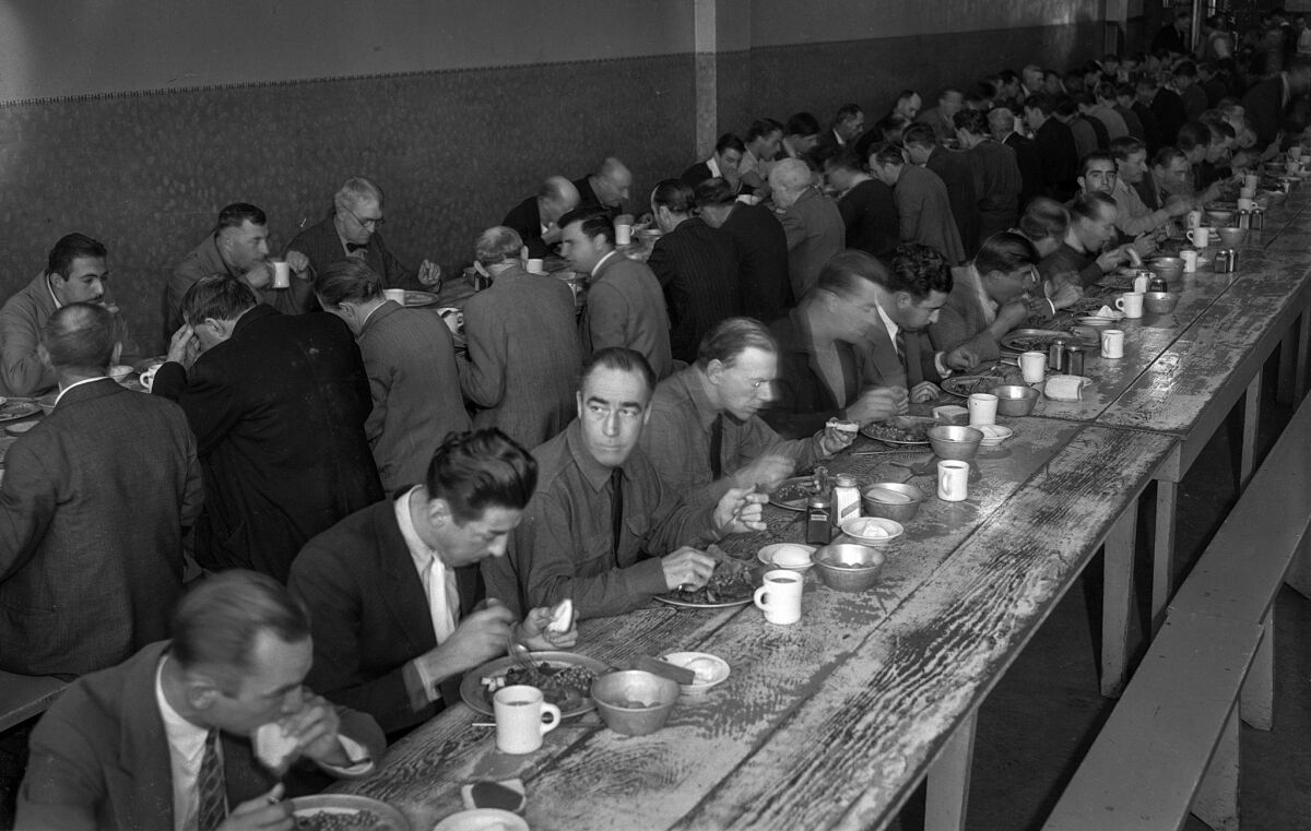 Nov. 28, 1935: Men enjoy Thanksgiving dinner at the Midnight Mission in Los Angeles.