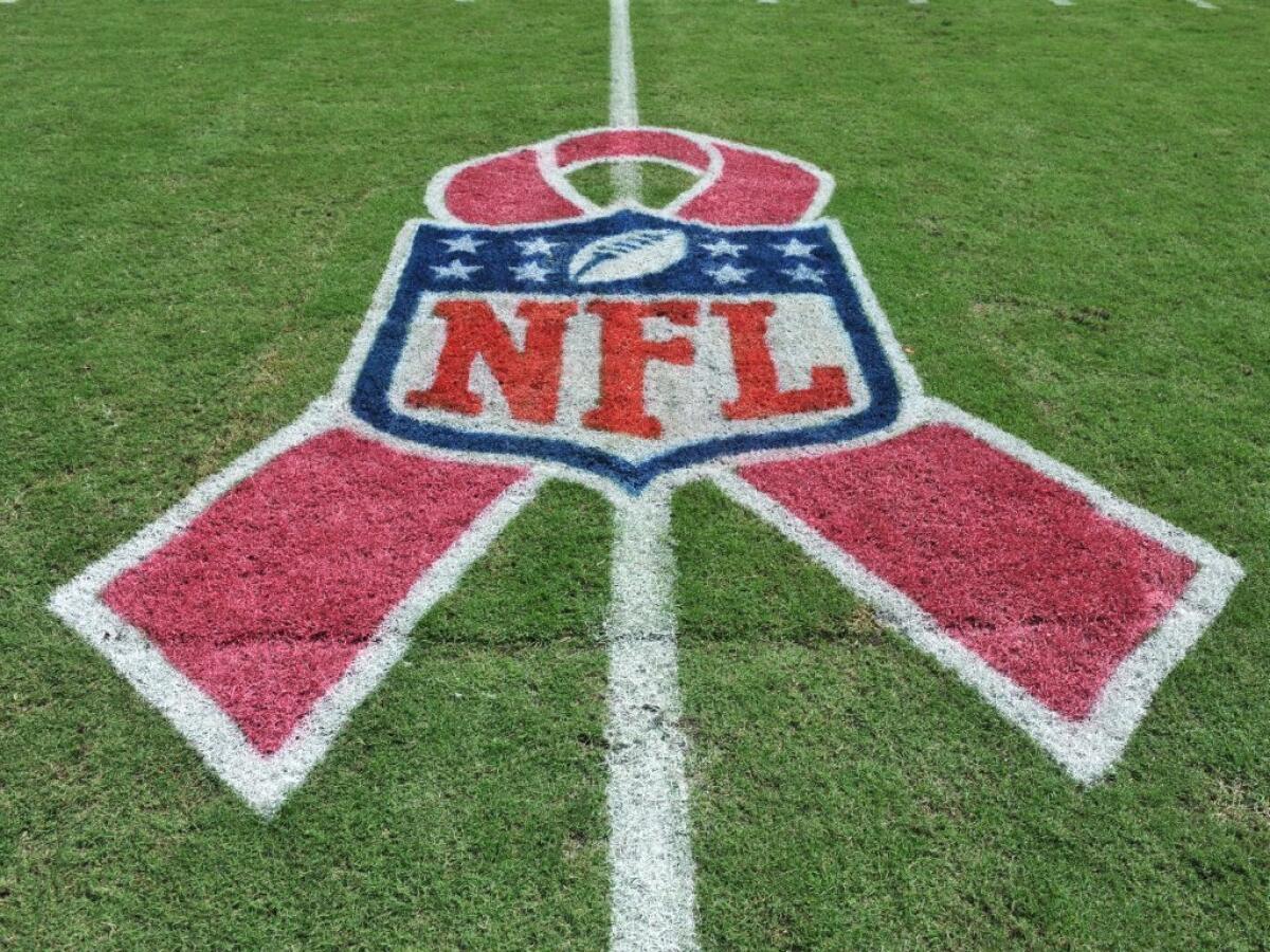 Football field in Tampa, Fla., for a game between the Tampa Bay Buccaneers and the Philadelphia Eagles, displays pink ribbon in support of October's breast cancer awareness month effort. How much good do these campaigns do?