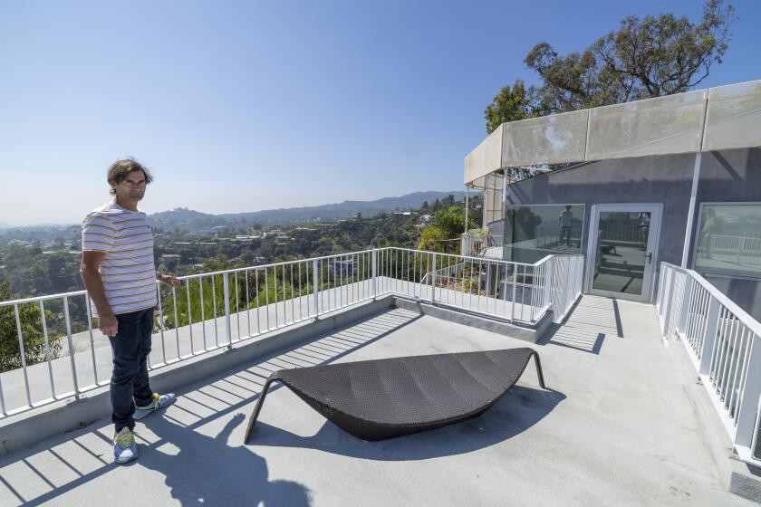 Los Angeles, CA - September 25: Aleksandar Jovanovic, a Airbnb landlord, looks out over a patio space on top his guesthouse, located on the property of his Los Angeles home. His tenant, Elizabeth Hirschhorn, not pictured, is still living in his guesthouse listed on Airbnb after the lease ended nearly two years ago without paying rent. Photo taken in Los Angeles Monday, Sept. 25, 2023. (Allen J. Schaben / Los Angeles Times)