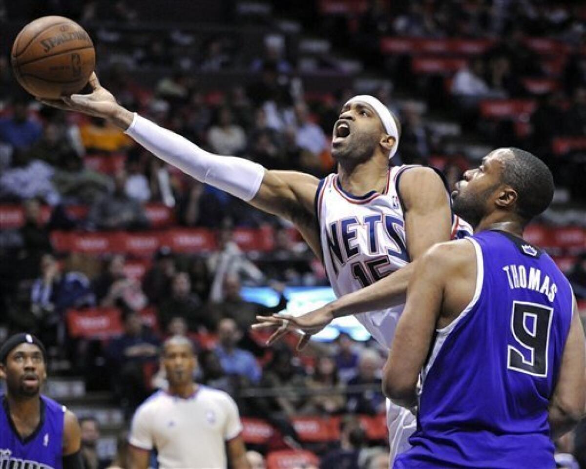 The New Jersey Nets player Vince Carter goes and hits a huge dunk