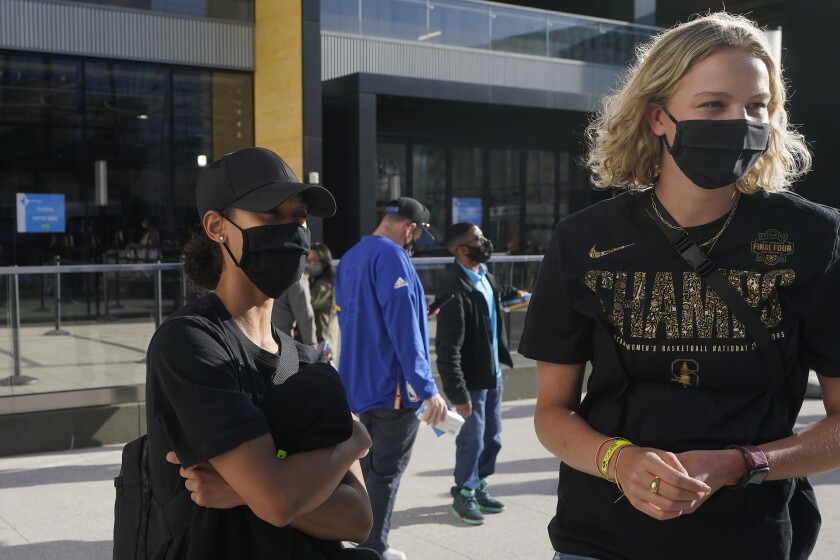 Stanford basketball players Anna Wilson, left, and Alyssa Jerome are interviewed as they arrive at Chase Center before an NBA basketball game between the Golden State Warriors and the Utah Jazz in San Francisco, Monday, May 10, 2021. (AP Photo/Jeff Chiu)