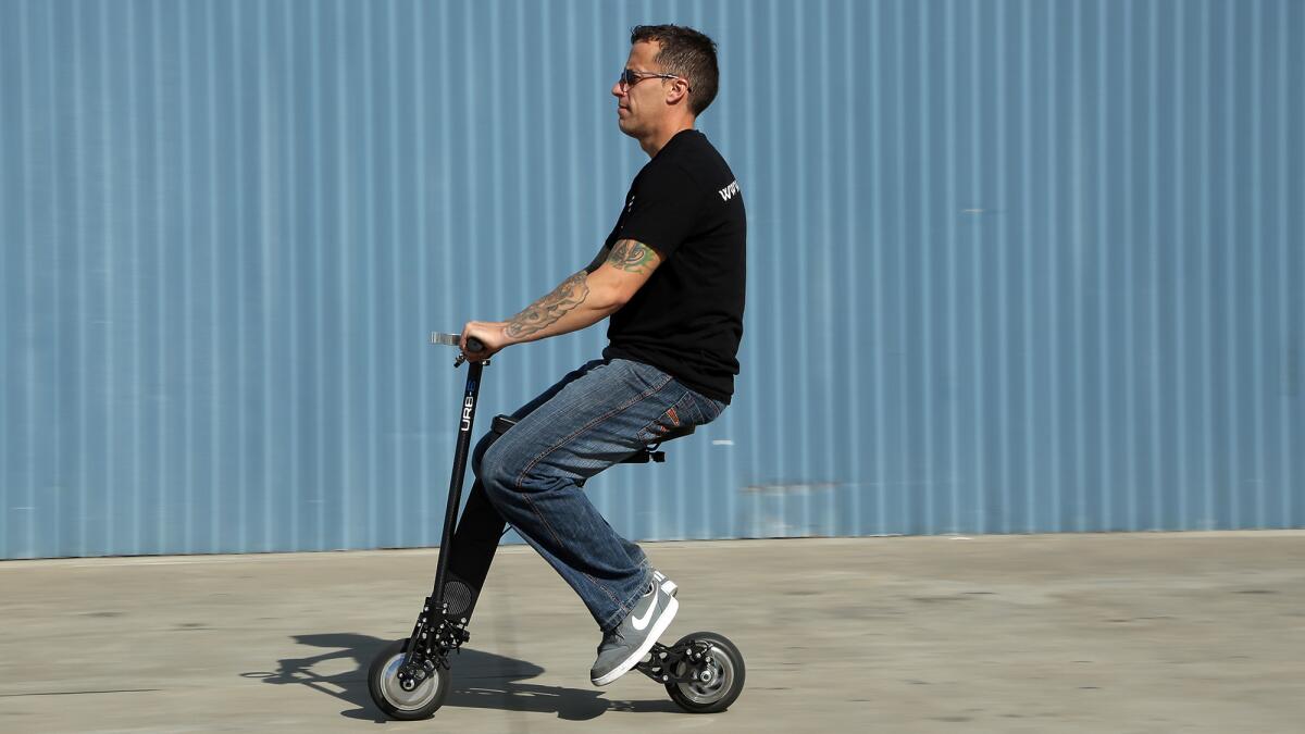 Casey Day demonstrates an URB-E personal scooter. The $1,499 scooter is made in Pasadena.