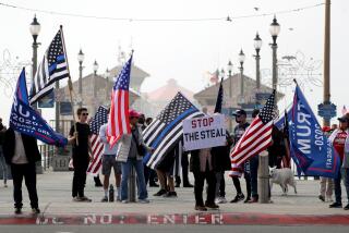 President Trump supporters waved flags and held signs during election rally at the Huntington Beach pier in Huntington Beach on Wednesday, Jan. 6, 2020. About 200 people waves flags, played musis and danced in support of President Donald Trump.