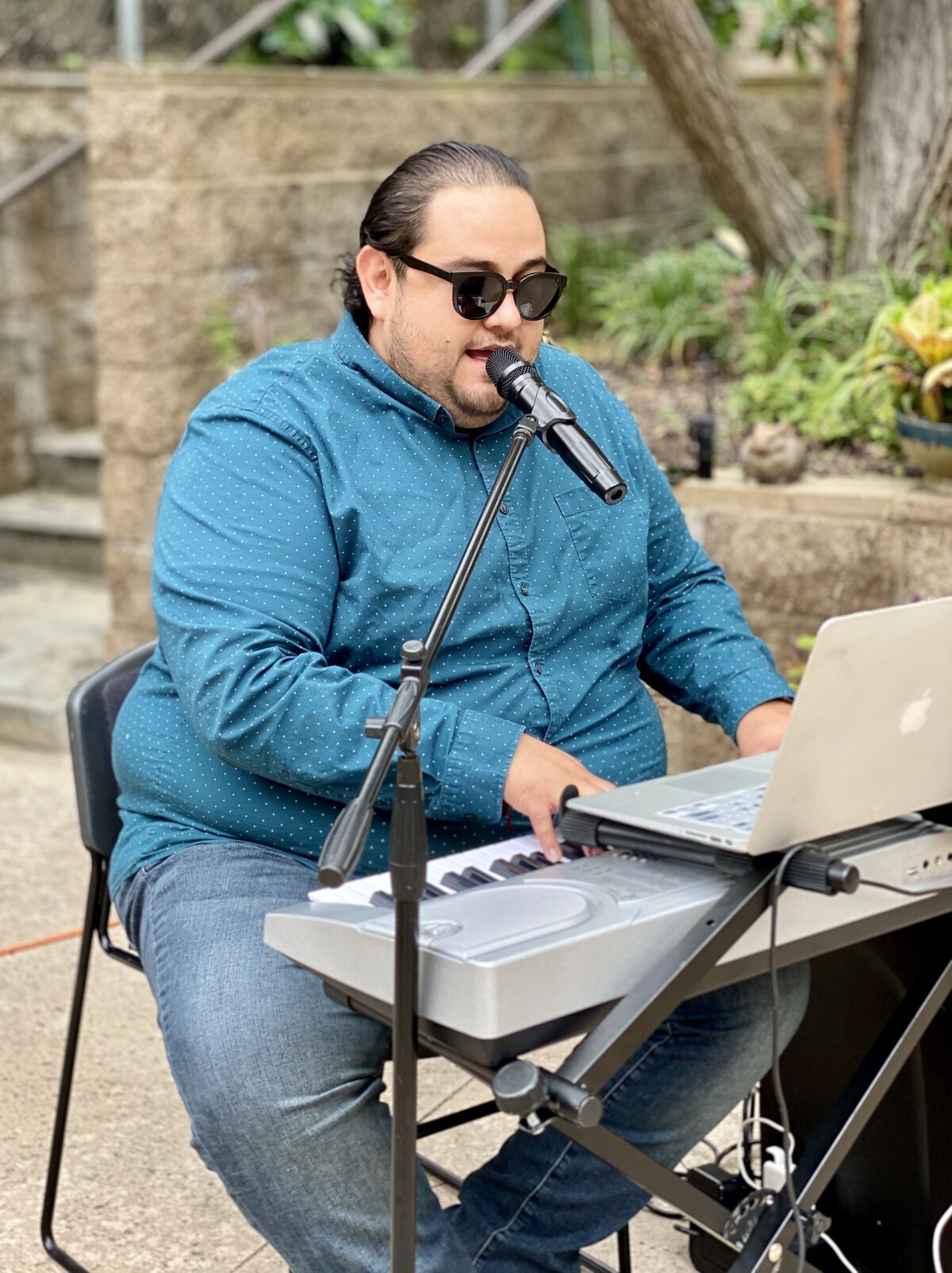 Gizeh Guevara sings for Chateau La Jolla residents from a distance during a series of concerts at the complex.