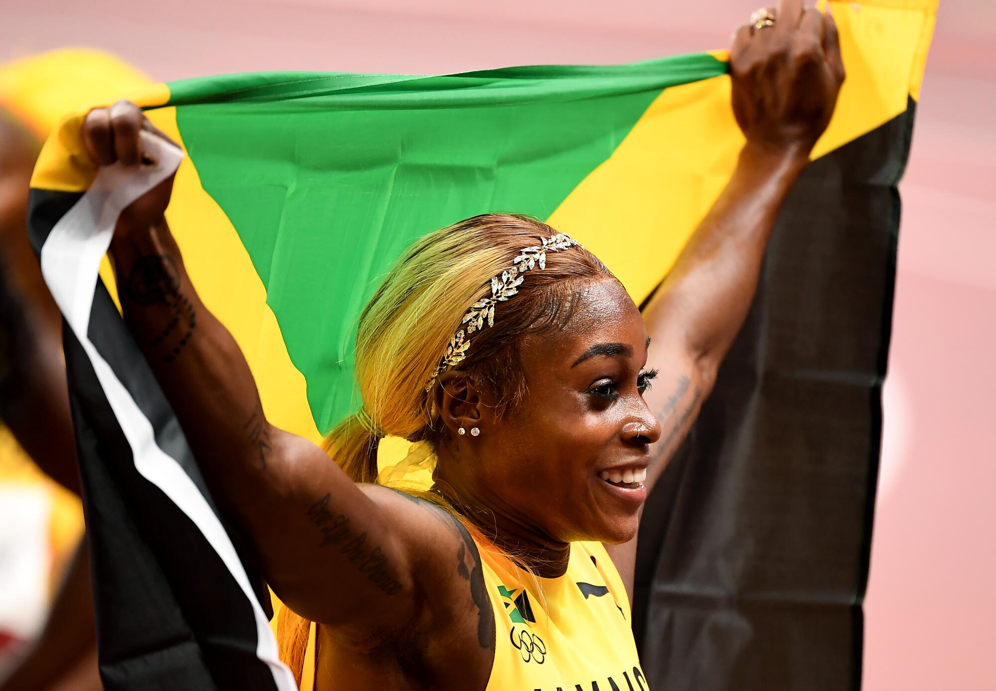 Jamaica's Elaine Thompson-Herah celebrates the gold medal in the 100m final.