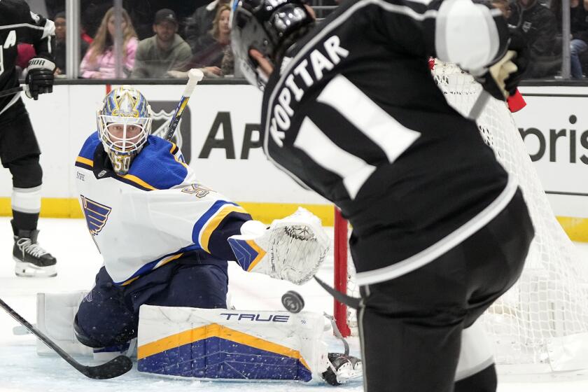 Los Angeles Kings center Anze Kopitar, right, attempts to score on St. Louis Blues.