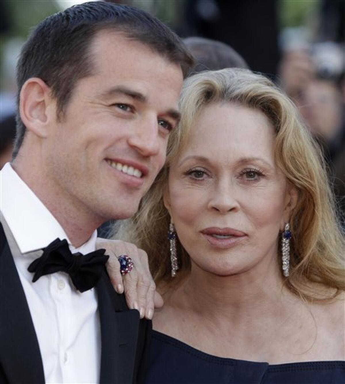 In this May 20, 2011 photo, actress Faye Dunaway, right, and her son Liam O'Neill arrive for the screening of This Must be the Place at the 64th international film festival, in Cannes, southern France. A New York landlord is suing Dunaway, claiming the actress' rent-stabilized apartment is not her primary residence. The New York Times says the suit was filed Tuesday, Aug. 2, 2011. The suit also names O'Neill as a subtenant of the Manhattan apartment. Dunaway and her son didn't return calls seeking comment. (AP Photo/Lionel Cironneau)
