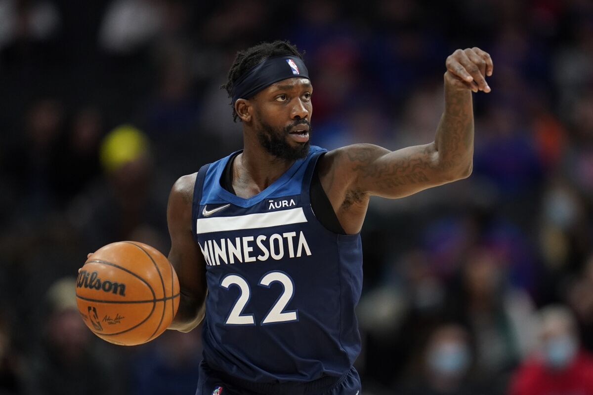 Minnesota Timberwolves guard Patrick Beverley points while dribbling the ball against the Detroit Pistons 