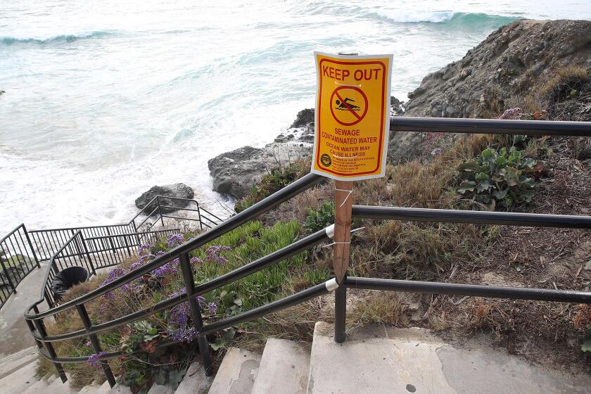 A sign warning beach-goers at the Cress St. stairs after a reported sewage spill in Laguna Beach. Officials said that the spillage was caused for a break in a force main sewer line, which has resulted in an estimated spillage of about 94,500 gallons.