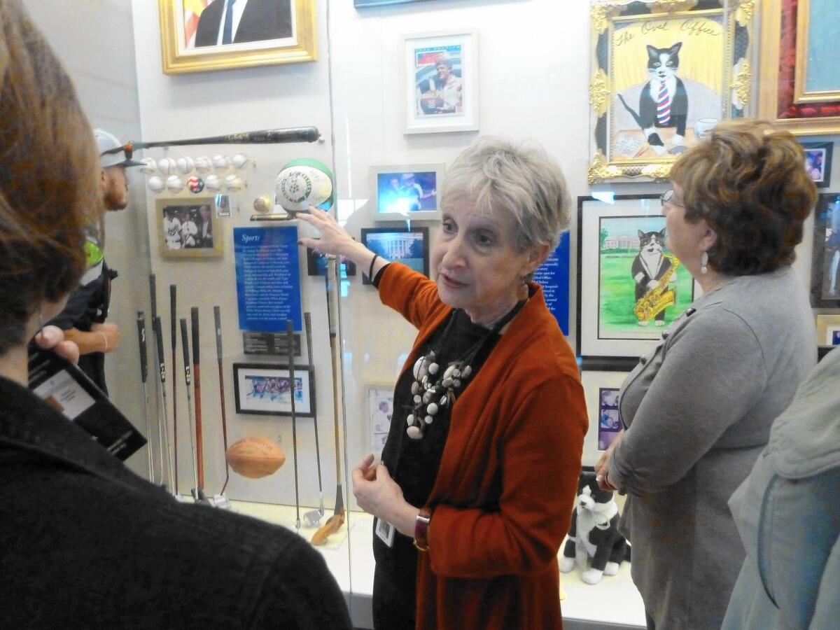 Ann Kamps, manager of volunteer and visitor services at the Clinton Presidential Center in Little Rock, Ark., leads a tour through the official shrine to the 42nd president.