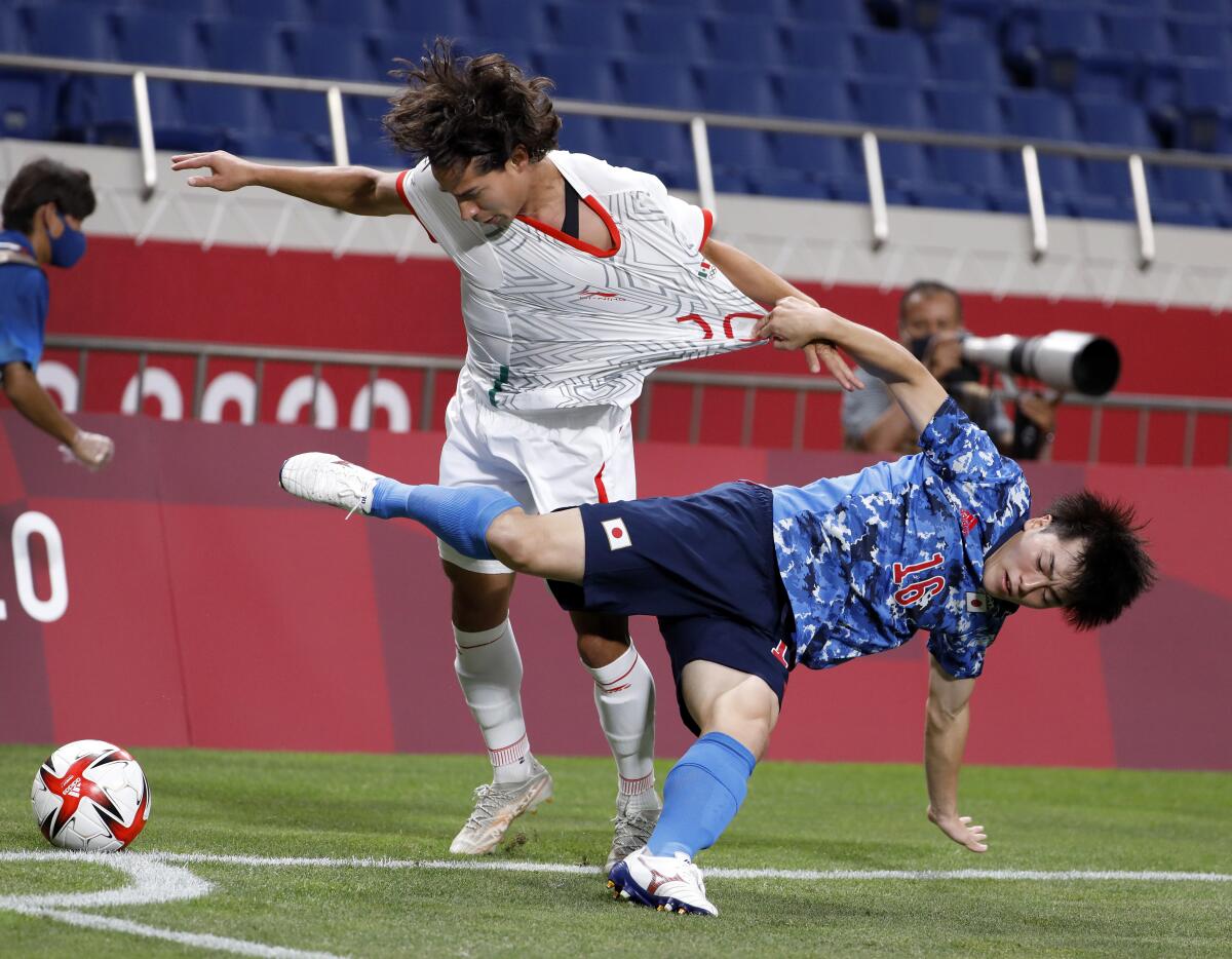Mexico's Diego Lainez and Japan's Yuki Soma tangle during Japan's win at Saitama Stadium on Sunday.