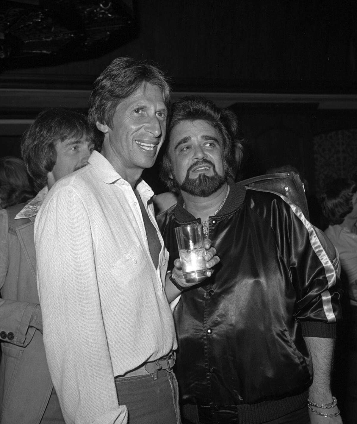 This 1979 photo released by the Las Vegas News Bureau shows David Brenner, left, and Wolfman Jack at the Riviera.
