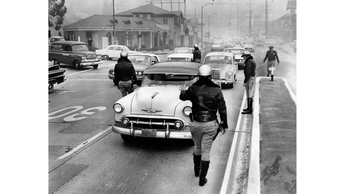 Dec. 21, 1961: California Highway Patrol officers conduct a traffic check on westbound Sunset Boulevard at Sunset Plaza Drive.