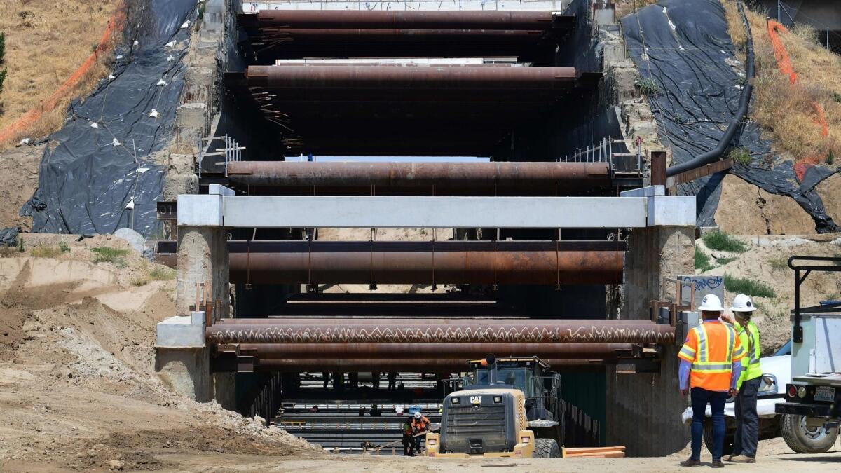 A construction crew works May 8 on part of the high-speed railway line that will cross beneath Highway 180 in Fresno.