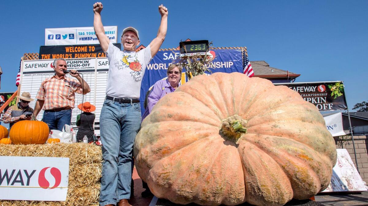 Joel Holland throws his arms into the air Oct. 9 after winning the 44th World Championship Pumpkin Weigh-Off in Half Moon Bay, Calif.