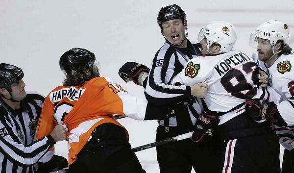 Officials break up the fight between Philadelphia's Scott Hartnell after he put a hit on Tomas Kopecky in the second period of Game 3.