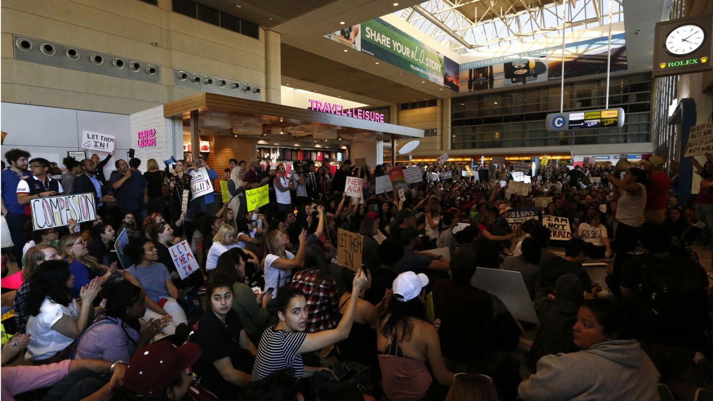 Hundreds take part in an impromptu sit-in at the Tom Bradley International Terminal at LAX.