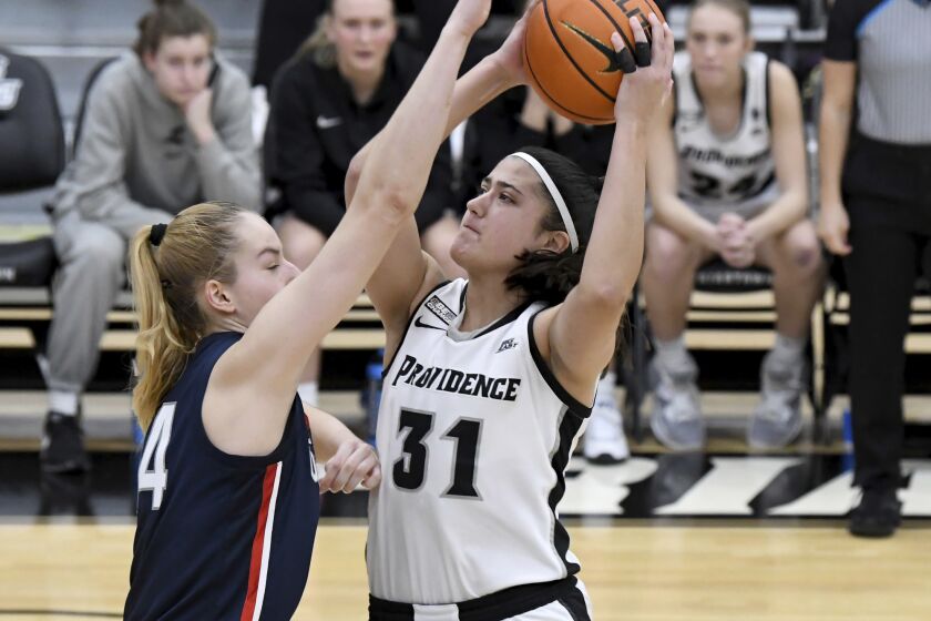 UConn's Dorka Juhász blocks a layup made by Providence's Olivia Olsen (31) during the second half of an NCAA college basketball game, Wednesday, Feb. 1, 2023, in Providence, R.I. (AP Photo/Mark Stockwell)