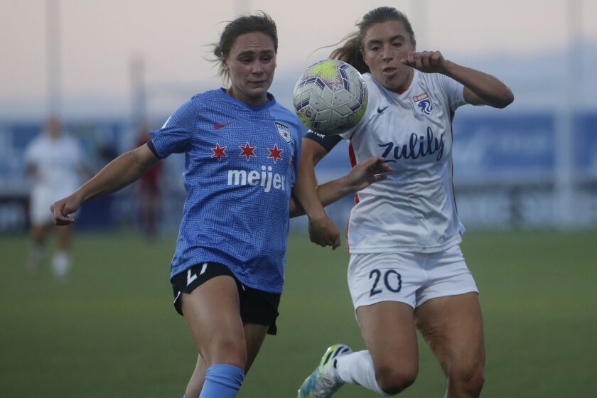 Chicago Red Stars' Bianca St Georges, left, and Reign's Sofia Huerta (20) battle for the ball at Zions Bank Stadium