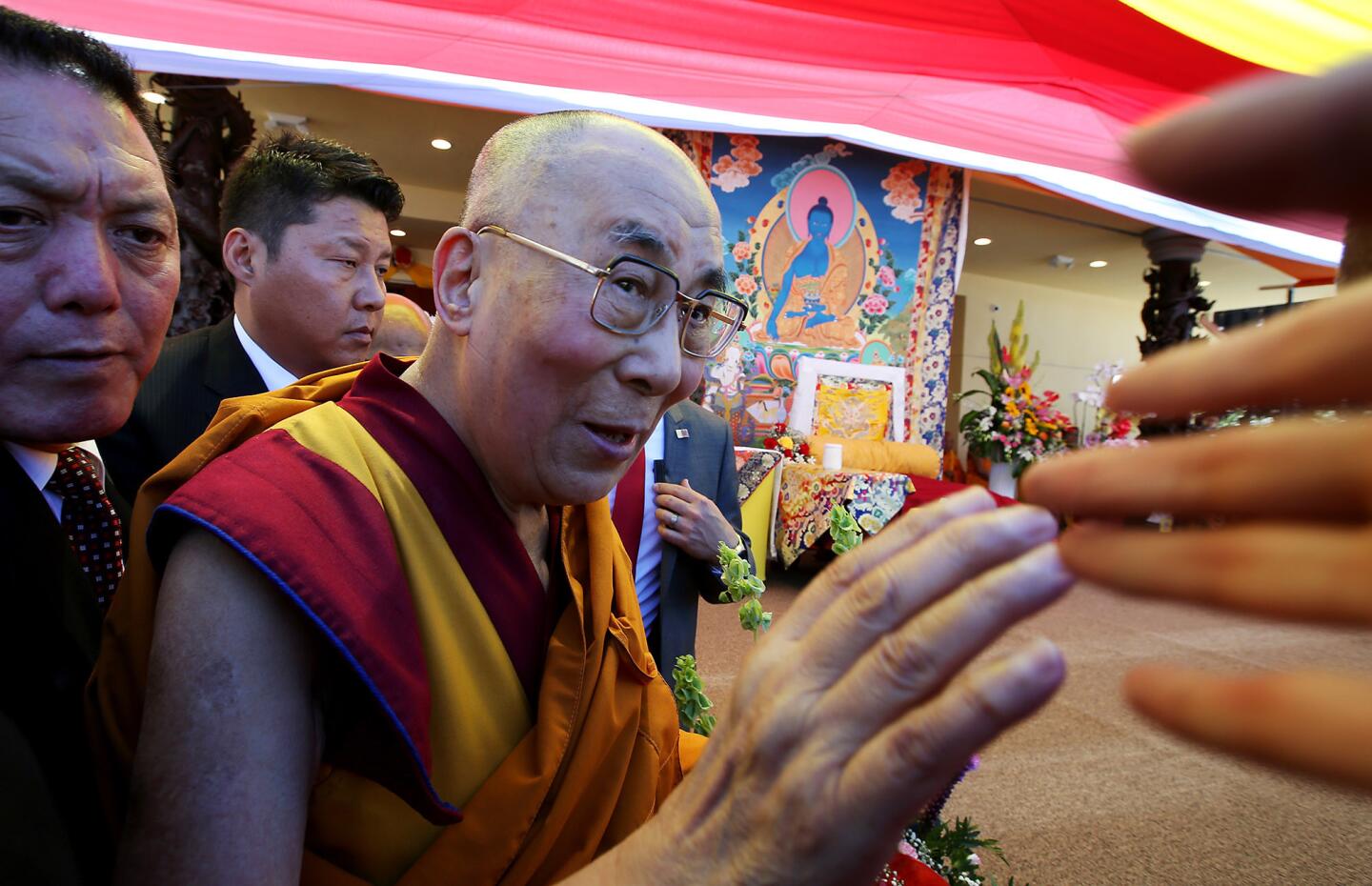 The Dalai Lama greets people during the opening of Chua Dieu Ngu Buddhist temple in Westminster on Saturday.