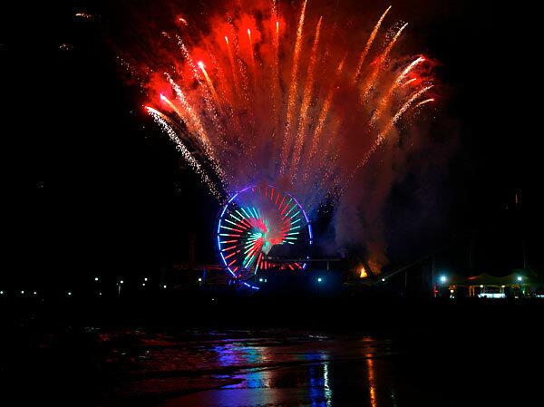 Fireworks light up the sky over the Santa Monica Pier during a ceremonial lighting of the new Ferris wheel at Pacific Park. The new wheel uses 160,000 energy-efficient LED lights, providing a 75 percent greater energy savings than the previously used incandescent bulbs.
