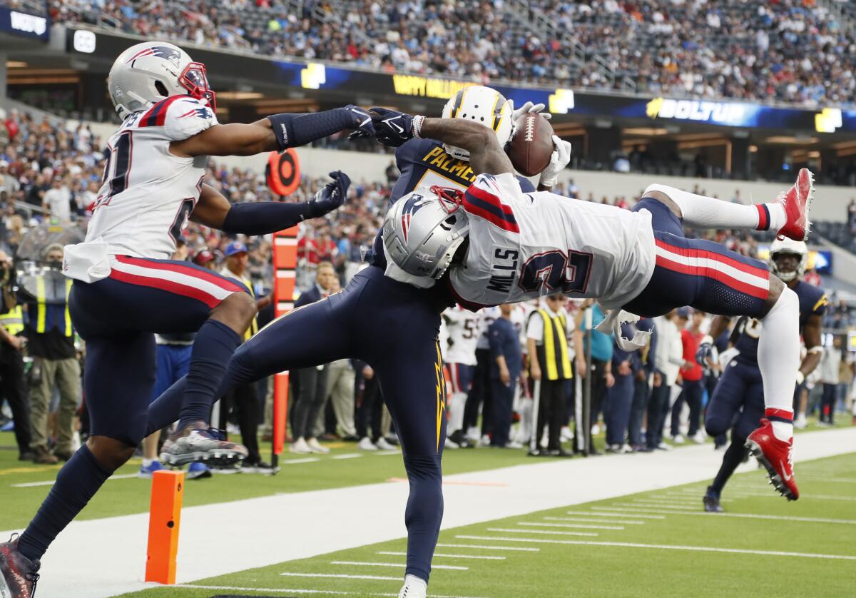 Chargers wide receiver Joshua Palmer makes a spectacular TD catch over Patriots Jalen Mills (2) and Adrian Phillips.