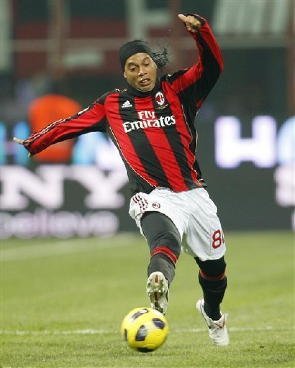 FILE - AC Milan Brazilian forward Ronaldinho controls the ball during the Serie A soccer match between AC Milan and Brescia at the San Siro stadium in Milan, Italy, in this Saturday, Dec. 4, 2010 photo from files. Ronaldinho's brother and agent said Monday, Jan. 3, 2011 the playmaker is negotiating a return to Brazil from AC Milan, with three top clubs lining up to sign him. The 30-year-old Ronaldinho is currently in Brazil and his brother Roberto Assis says Flamengo, Gremio and Palmeiras are all trying to sign the player, with a deal expected to be sealed in a few days' time. (AP Photo/Antonio Calanni, File)
