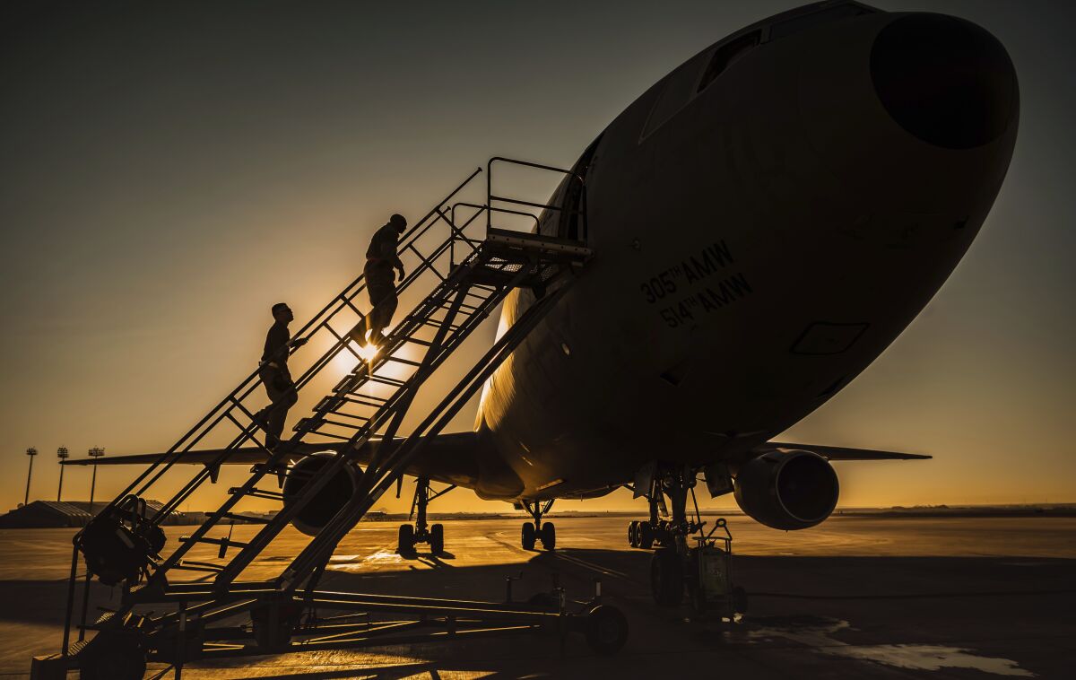 In this Jan. 5, 2021 photo from the U.S. Air Force, two KC-10 Extender crew chiefs board the aircraft at Al-Dhafra Air Base, United Arab Emirates. An Air Force KC-10 Extender that flew out of Al-Dhafra Air Base in the United Arab Emirates on Sunday, May 2, 2021, used the call sign "PIKLRICK" on a mission that saw it fly east out over the Gulf of Oman, according to flight-tracking data. The call sign appears to be a nod to an episode of the cartoon "Rick and Morty" in which one of the titular characters turns himself into a pickle to escape a family therapy session. (U.S. Air Force/Staff Sgt. Trevor T. McBride, via AP)