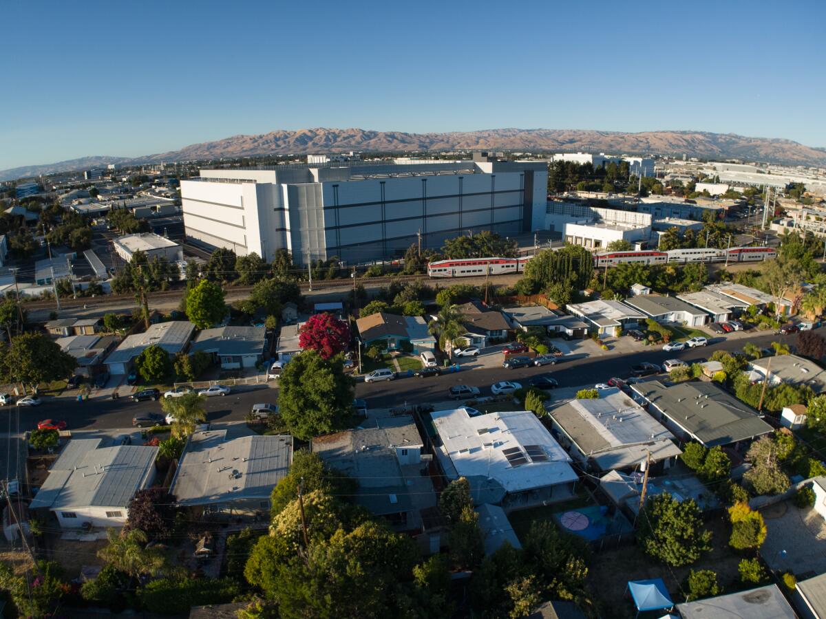 A large building among homes.