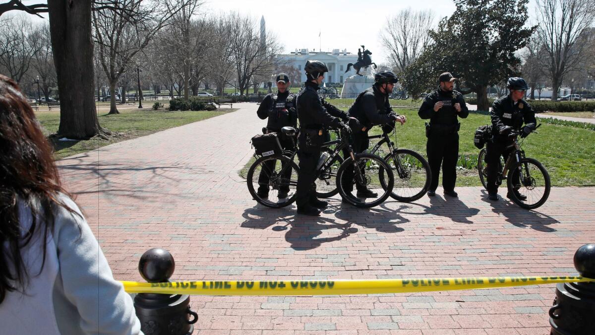 U.S. Secret Service officers gather in cordoned-off Lafayette Park after a security incident near the fence of the White House in Washington, D.C. on Saturday, March 18.