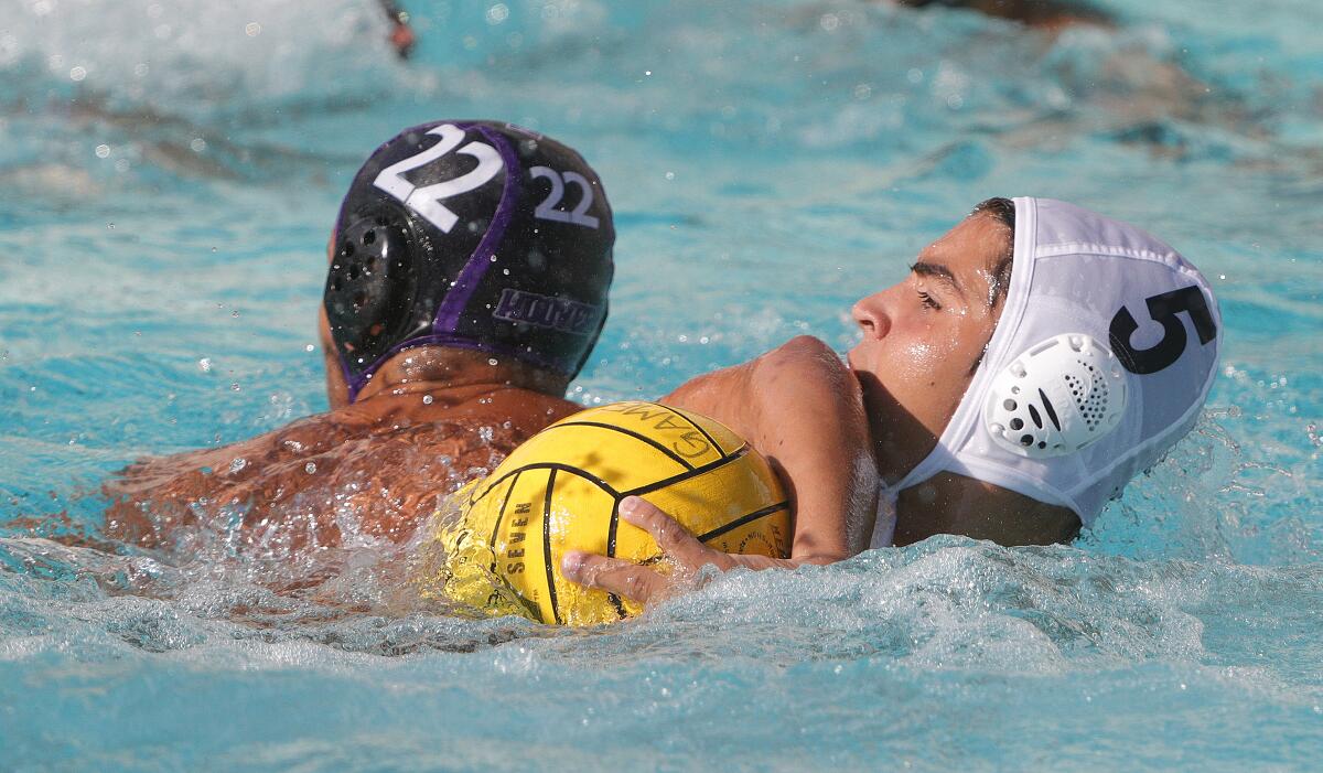 Hoover's Kayk Yengibaryan and Burbank's Pavel Tantchev tangle their arms for control of the ball in a Pacific League boys' water polo match at Hoover High School on Thursday, October 10, 2019. Hoover won the match.