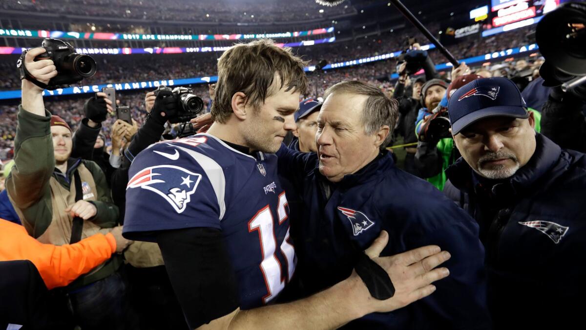 New England Patriots quarterback Tom Brady, left, hugs coach Bill Belichick after the AFC championship in January.