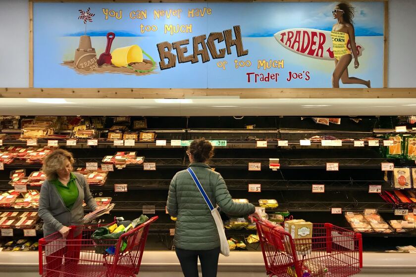 HERMOSA BEACH. CA. MARCH 13, 2020 - Shoppers browse through barren shelfs at a Trader Joe's in Hermosa Beach Friday, March 13, 2020. (Jay L. Clendenin / Los Angeles Times)