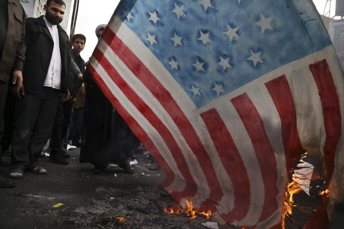 Demonstrators set fire to a rendition of the U.S. flag during a rally in front of the former U.S. Embassy in Tehran on Monday.