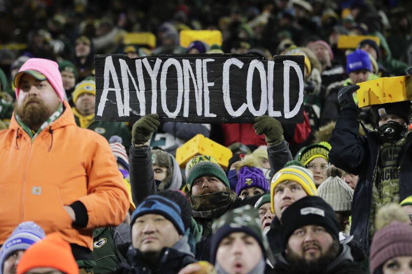 Fans watch during the first half of an NFL football game between the Green Bay Packers and the Minnesota Vikings at Lambeau Field Sunday, Jan. 2, 2022, in Green Bay, Wis. (AP Photo/Aaron Gash)