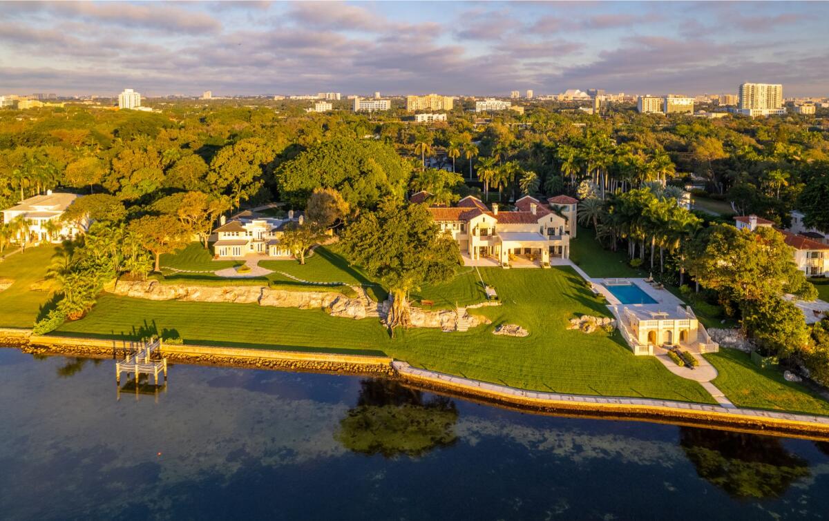 The four-acre estate includes 400 feet of water frontage and two mansions that combine for more than 20,000 square feet.