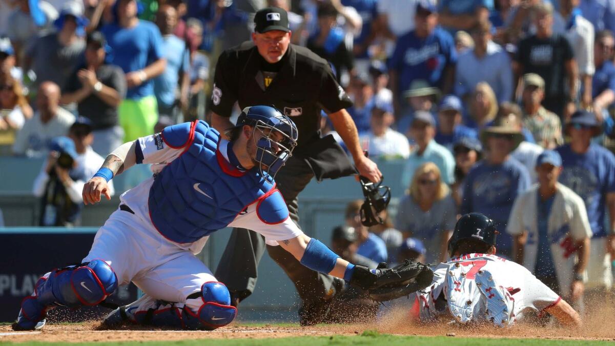 Dodgers catcher Yasmani Grandal is late with the tag on Nationals centerfirelder Trea Turner who scored on a Jayson Werth triple in the third inning.