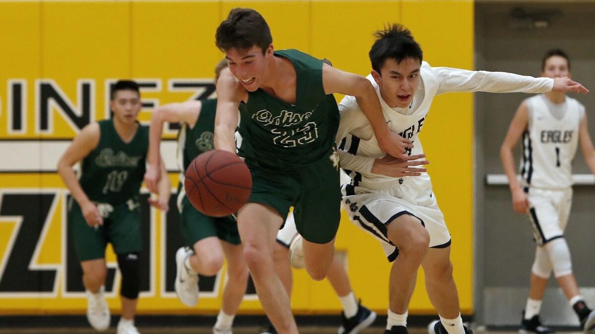 Edison High's Bradley Luna, left, steals the ball away from Calvary Chapel's Kyle Thorin during the first half of the Grizzly Invitational at Godinez High on Nov. 28.
