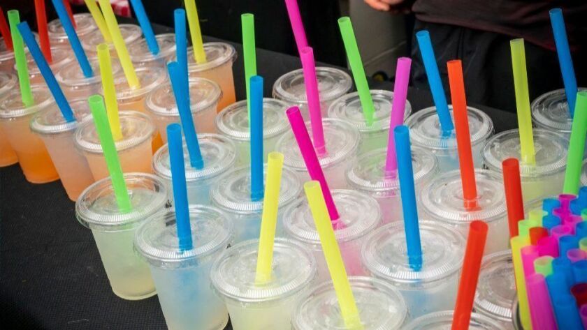 Plastic straws fill lemonade cups at a street fair in this 2018 file photo. Los Angeles is joining the state of California in requiring restaurants to give out plastic straws only by request.