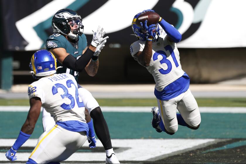 Los Angeles Rams' Darious Williams (31) intercepts a pass intended for Philadelphia Eagles' J.J. Arcega-Whiteside (19) during the second half of an NFL football game, Sunday, Sept. 20, 2020, in Philadelphia. (AP Photo/Laurence Kesterson)