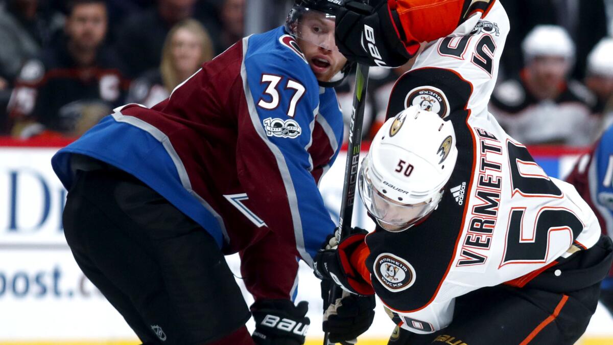 Ducks center Antoine Vermette battles Avalanche left wing J.T. Compher during the second period Friday.