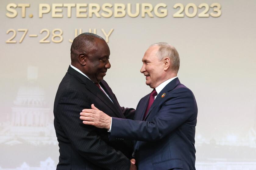 FILE - President of the Republic of South Africa Cyril Ramaphosa, left, and Russian President Vladimir Putin shake hands in St. Petersburg, Russia, Thursday, July 27, 2023. South Africa will host a meeting of nations participating in the U.S. Africa Growth and Opportunity Act despite earlier calls to exclude the country from the forum due to its ties to Russia and the docking of a sanctioned Russian vessel near Cape Town last year. (Sergei Bobylev/TASS Host Photo Agency Pool Photo via AP, File)
